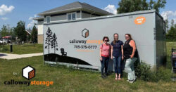 Calloway staff in front of portable storage container with Lighthouse staff